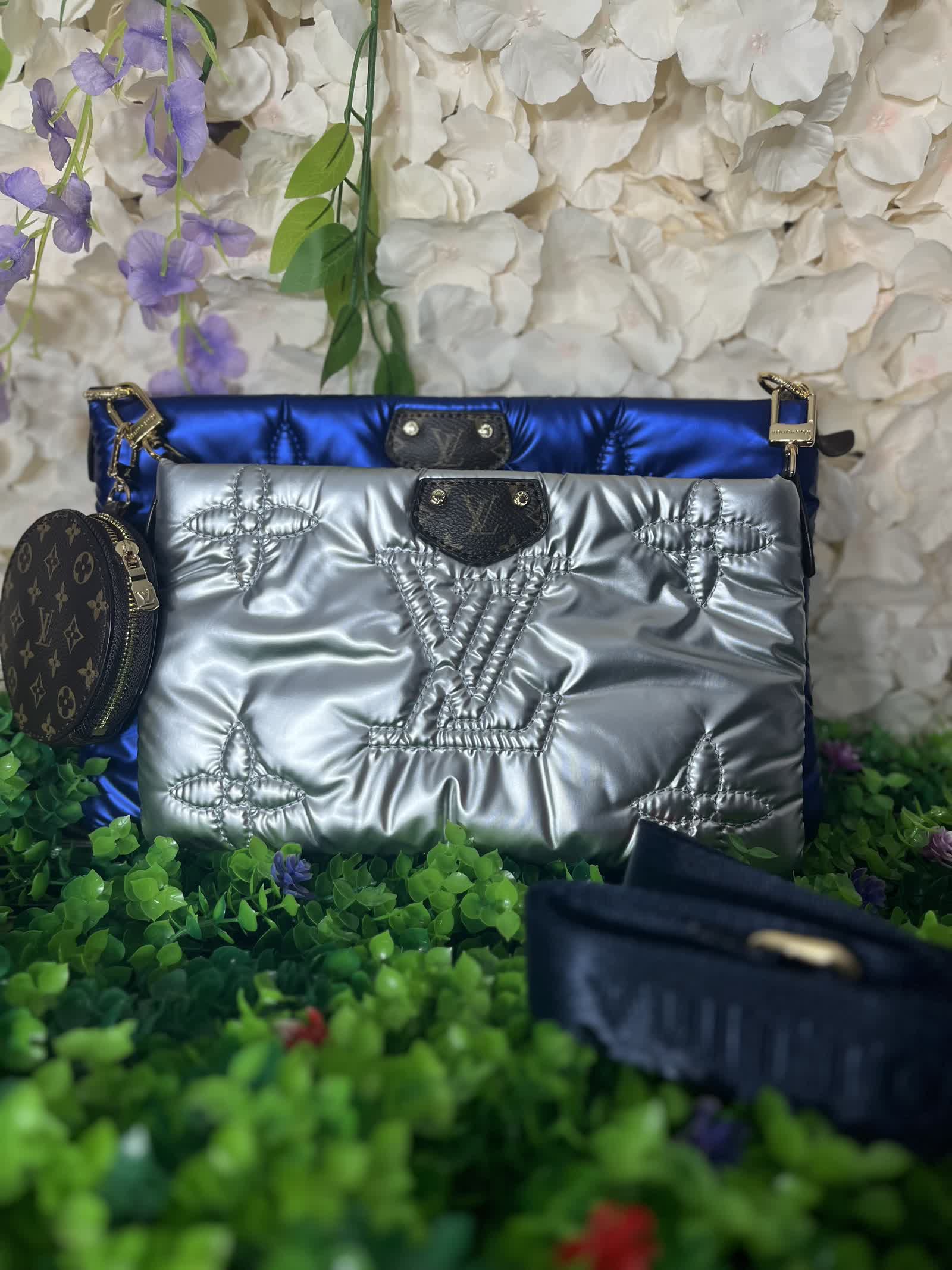 Silver and royal blue metallic puffer pouches with gold hardware